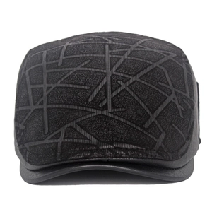 Close-up of gray textured flat cap featuring a black leather brim and geometric patterns