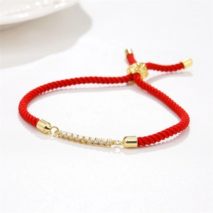 Adjustable red braided rope bracelet with gold bar and sparkling cubic zirconia stones