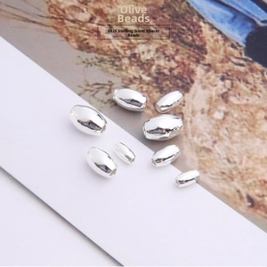 Detailed view of assorted S925 sterling silver olive-shaped spacer beads for DIY jewelry