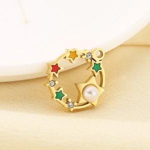 Detail of 18K gold star pendant with colorful enamel, pearl, and crystal accents