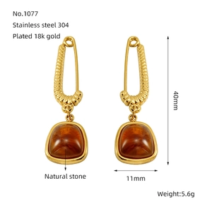 Macro detail of paperclip earrings with amber natural stone and 18k gold plating