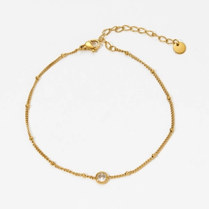 Elegant gold plated stainless steel anklet with white zircon and small beads on white background