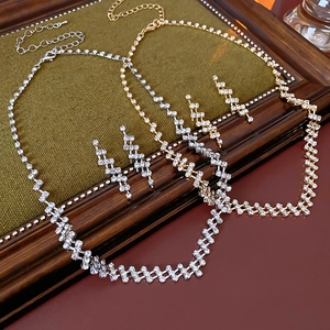 Close-up of gold and silver rhinestone jewelry sets with square mesh design in vintage frame