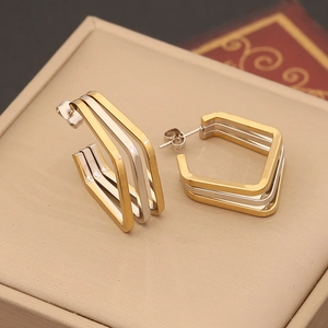 Modern geometric two-tone hexagonal stud earrings with layered gold and silver finish