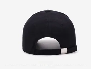 Detail of black washed cotton baseball cap featuring an adjustable silver metal buckle