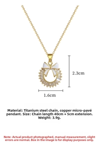 Macro detail of bow-knot pendant necklace showing dimensions 2.3x1.6cm and titanium steel chain