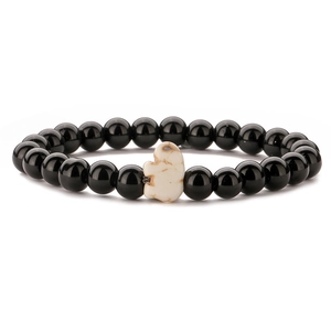 Detail view of elastic bracelet with black beads and a white stone elephant charm