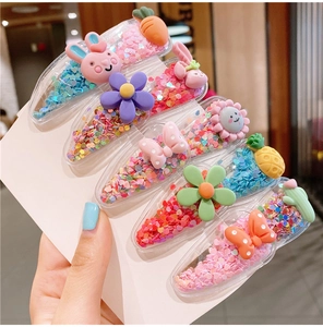 Close-up of cute glitter resin hair clips with colorful sequins and cartoon charms
