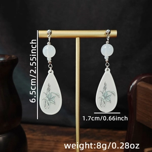 Detail showing dimensions of Chinese style floral teardrop earrings on a display stand