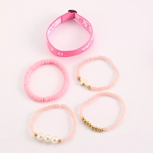 Detail view of 5-piece pink bracelet set with cross, beads and woven wristband
