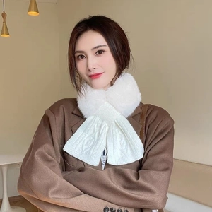 Detail of white faux fur and cable knit texture on a stylish women's winter scarf