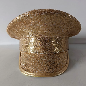 Detailed close-up of shiny gold sequins and texture on the flat-top military party hat