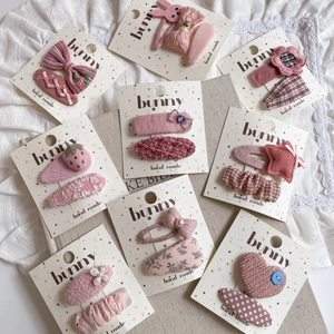 Pink fabric hair clips set with cute bow, star, and flower patterns for girls