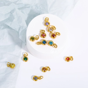 Macro shot of colorful round cubic zirconia charms with gold plated stainless steel frames