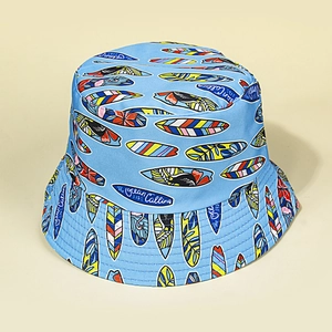 Detailed view of sky blue sun hat featuring colorful surfboard patterns and ocean text