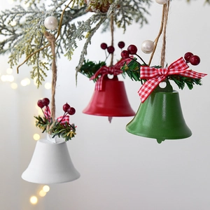 Three-color Christmas metal bells with pine needles and plaid bows on tree branches