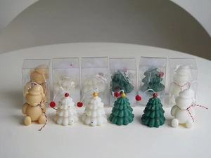 Detail showing mini Christmas tree and bear scented candles in individual gift boxes