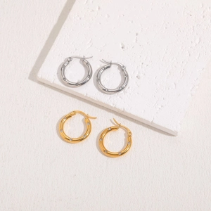 Polished titanium steel hoop earrings with white zircons in gold and silver finishes