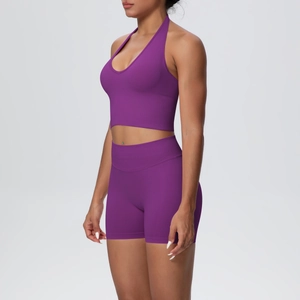 Detail of purple ribbed yoga set featuring halter neck top and high waist shorts