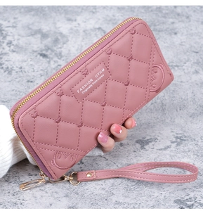 Detail of pink PU leather wallet with quilted diamond stitching and wrist strap
