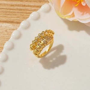 French vintage gold nail spiral ring with sparkling zircons on a white ceramic plate