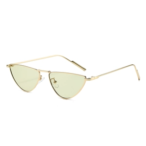 Golden cat-eye sunglasses with triangular light green lenses shown at 45-degree angle