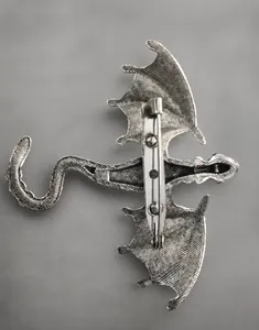 Detailed back view of the vintage dragon brooch showing the metal pin fastener