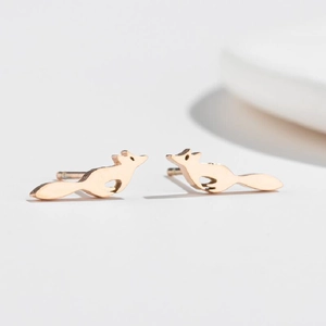 Detail of elegant rose gold running fox stud earrings showing fine metal craftsmanship