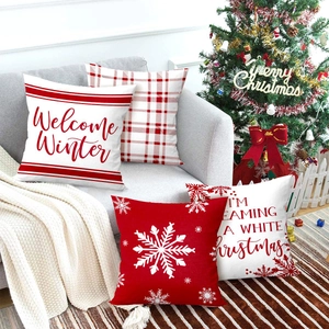 Set of four red and white Christmas pillow covers with snowflakes and winter slogans