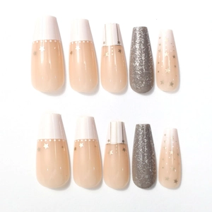 Detail of pink long ballerina press-on nails with white dots, gold stars, and grey glitter