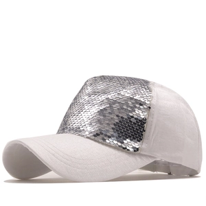 White baseball cap with sparkling silver sequins on the front panel and curved brim