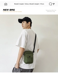Deep green canvas messenger bag worn by a male model for casual workwear street style