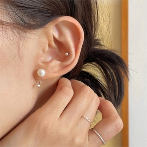Elegant 925 sterling silver freshwater pearl stud earring worn on model with ring