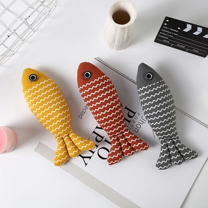 Three creative fish-shaped linen pet toys in yellow, orange and grey with wave patterns