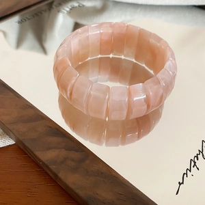 Close-up of translucent pink resin stretch bracelet with rectangular beads and texture