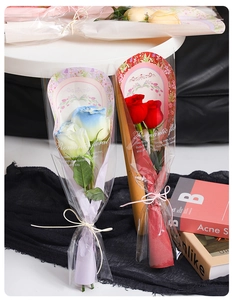 Detailed view of red and blue-white gradient roses in romantic floral gift packaging