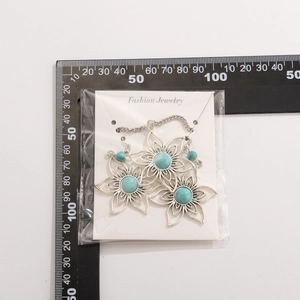 Detail of vintage silver earrings with turquoise stones and measuring scale reference