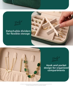 Detail of velvet jewelry box with adjustable dividers and necklace hooks for storage