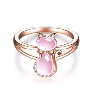 Detail of rose gold cat ring featuring pink quartz stones and sparkling white zircons