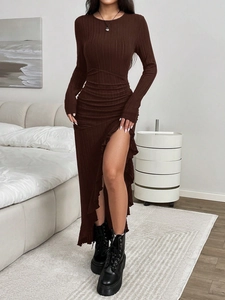 Close-up of the ribbed knit fabric and ruffled asymmetric hem on a brown midi dress