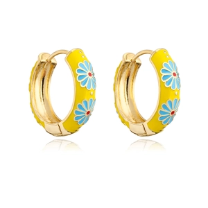 Close-up of gold-plated hoop earrings with yellow enamel and blue daisy floral pattern