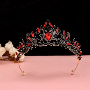 Detailed macro of a Gothic crown with red crystal teardrop and dark metal filigree