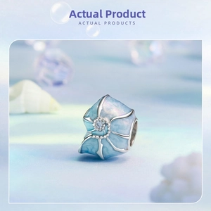 Close-up of S925 silver ocean shell charm with blue enamel and sparkling zircon stone