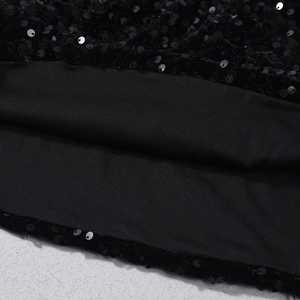 Detailed macro view of black sequins and soft knit lining on a stylish cropped top