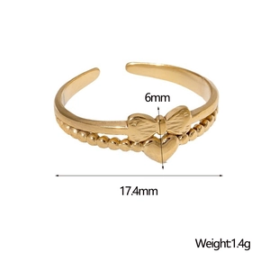 Detail view of gold bow ring with heart pendant showing 17.4mm inner diameter size