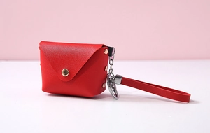 Detail of red PU leather envelope coin purse with gold snap and wrist strap