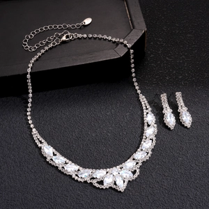 Detailed view of silver necklace and earrings set with marquise and teardrop crystals