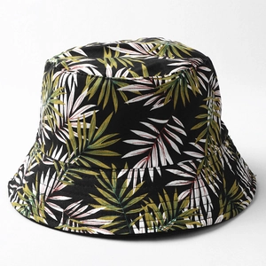 Detailed view of leaf pattern bucket hat with premium green and white palm leaf embroidery