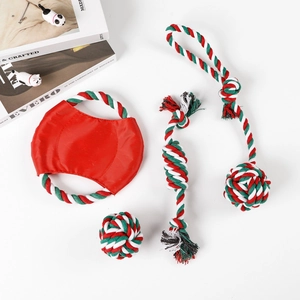 Close-up of Christmas themed dog cotton rope toy set with festive red and green colors