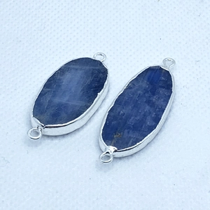 Macro view of blue kyanite connectors with silver-plated frames for DIY jewelry